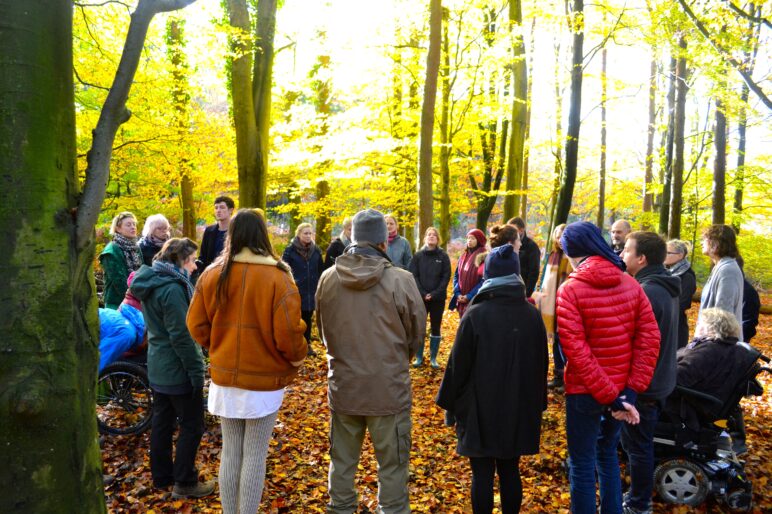 Singers standing in a woodland