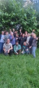 Gloucester folk choir smiling in the garden. 